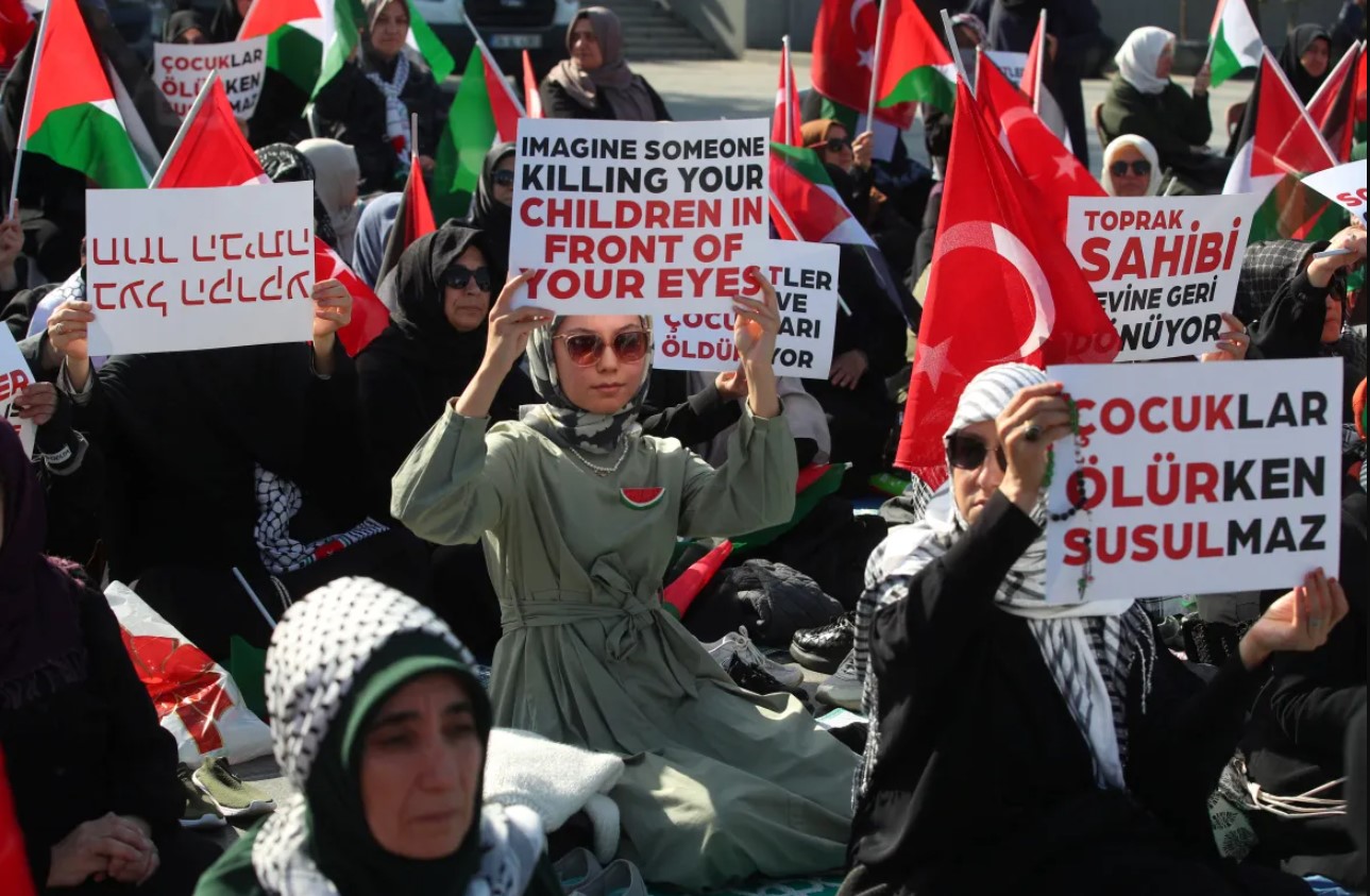 Pro-Palestinian demonstrators take part in a sit-in protest in Istanbul, Turkey.