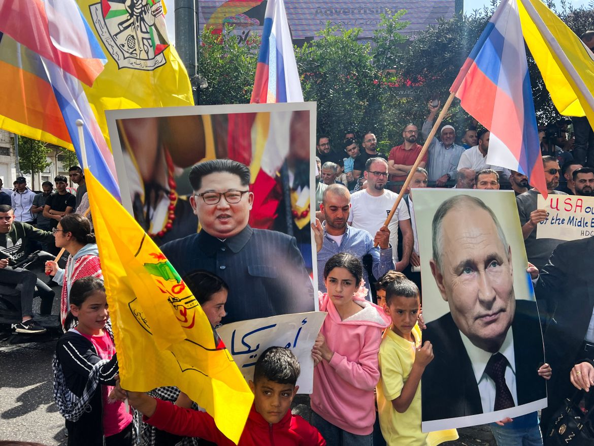 Palestinians hold pictures of the Russian President Vladimir Putin and North Korean leader Kim Jong-UN during a protest in support of the people of Gaza in Hebron in the Israeli-occupied West Bank.